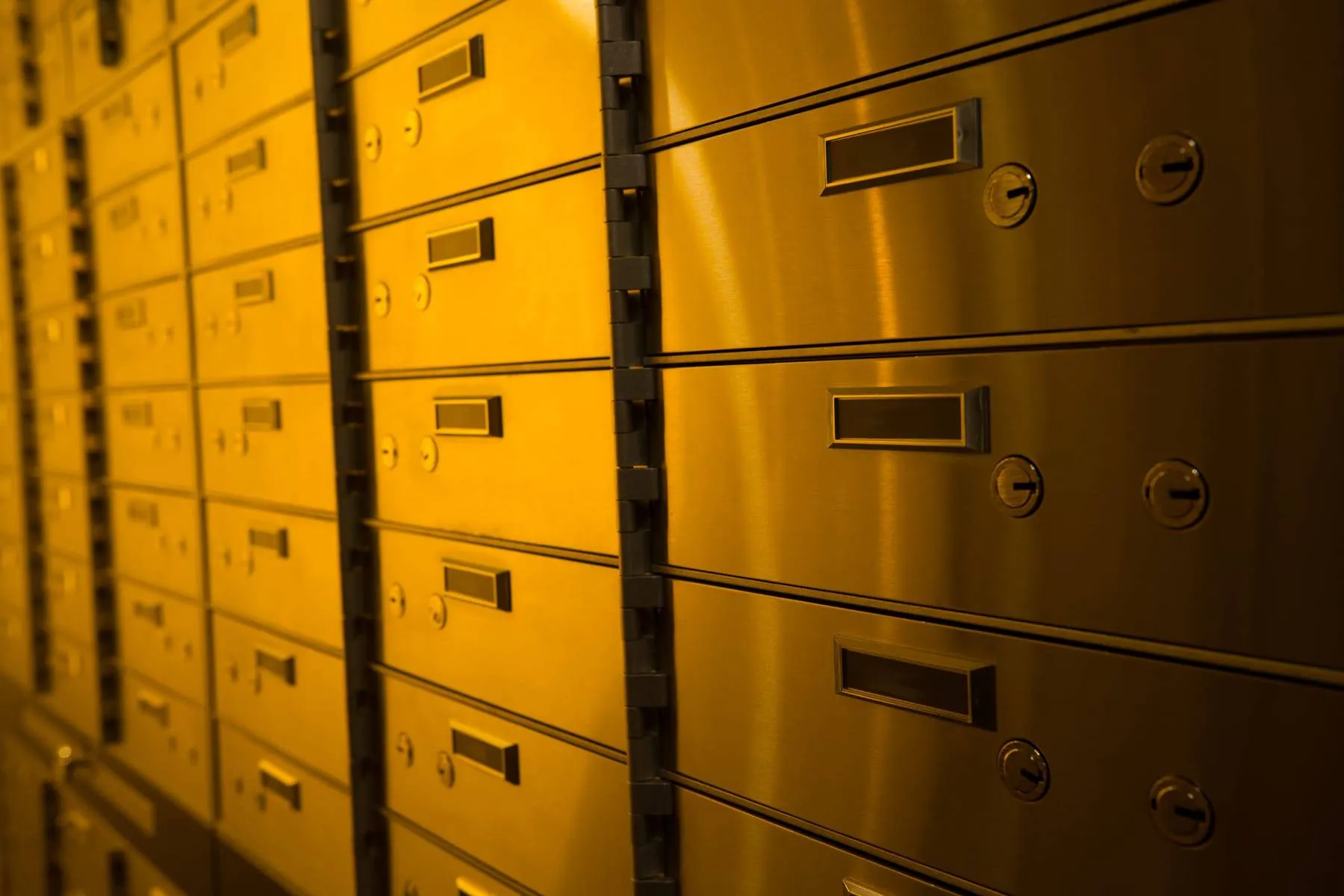 Gold-lit private safety deposit boxes at Fortis Vaults